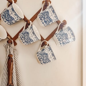 May include: A set of three ceramic mugs with a speckled, matte finish. The mugs are in shades of cream, light gray, and dark gray. Each mug has a simple, minimalist design, perfect for coffee or tea.