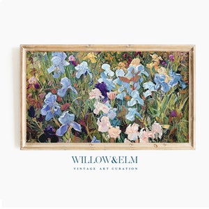 May include: A framed painting of a field of blue, purple, and white irises with green leaves and stems. The painting is in a light wood frame.