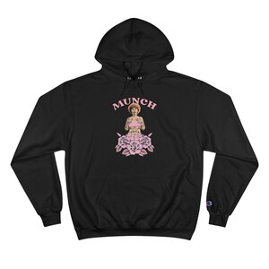 May include: Black hooded sweatshirt with a pink graphic of a woman with tattoos and the word "MUNCH" above her.