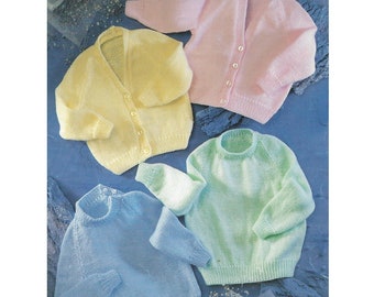 May include: Four knitted baby sweaters in different colors: light blue, light green, yellow, and pink. The sweaters are laid out on a blue surface.