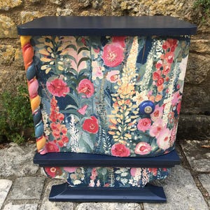 Vintage style wooden bedside table with a makeover. Modernized floral bedside table. Colorful side table.