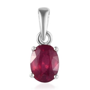 May include: A silver pendant featuring a red oval ruby gemstone.