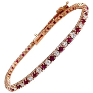 May include: A rose gold tennis bracelet with alternating round rubies and diamonds.