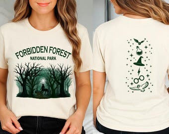 May include: A white t-shirt with a green graphic of a forest scene and the text "Forbidden Forest National Park". The back of the shirt has a green graphic of a wizarding themed design with a potion bottle, a hat, a lightning bolt, glasses, and an owl.