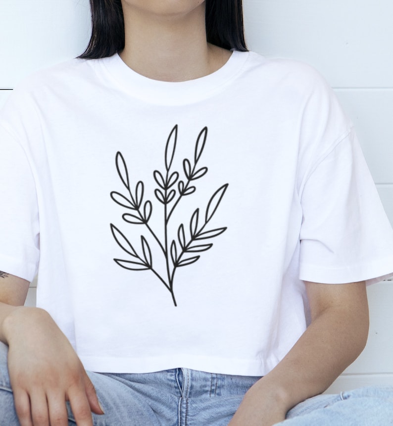 May include: A white cropped t-shirt with a simple black line drawing of a leafy branch.