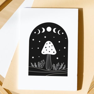 May include: Black and white illustration of a mushroom with a crescent moon and stars in the background. The mushroom is surrounded by crystals and foliage.