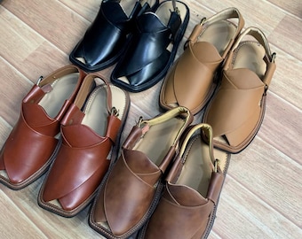 May include: Four pairs of leather sandals in brown, tan, and black. The sandals have a pointed toe and a strap that goes around the ankle.