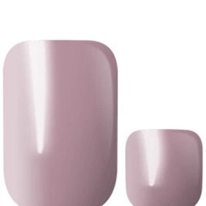 May include: Two sets of nude-colored press-on nails. The larger set is oval-shaped, while the smaller set is square-shaped.