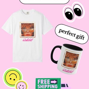 May include: White t-shirt and mug featuring a portrait with sunglasses and the word "Bullshit!". The mug has a black handle and interior. The image also includes stickers with text and smiley faces.