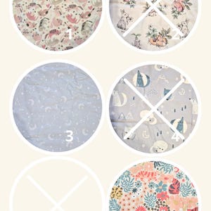 May include: A collection of six circular fabric swatches featuring various patterns: pink and grey animals, woodland creatures, white celestial motifs on blue, wolves and moons, a blank space, and a vibrant floral print with small tigers.