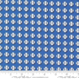 May include: Blue fabric with a white baseball pattern. The fabric has a white border with the words "moda" and "www.modafabrics.com" printed on it.
