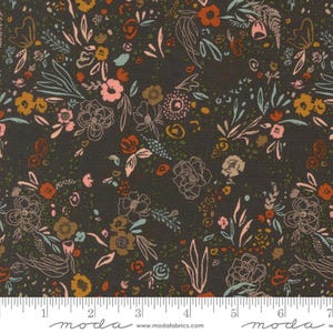 May include: Dark gray fabric with a floral pattern. The design features various flowers in shades of pink, orange, and yellow, with light blue and green accents. Outlined floral elements add detail. The fabric has a Moda Fabrics watermark.