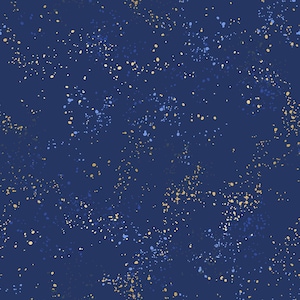May include: A dark navy blue background featuring a repeating pattern of small, scattered paint splatters in shades of light blue, pale yellow, and cream. The design creates a textured, speckled effect across the entire surface of the fabric.