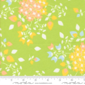 May include: A vibrant green fabric with a floral pattern. The design features clusters of yellow and peach flowers, along with blue and white accents. The fabric is decorated with white leaf shapes and delicate stems.