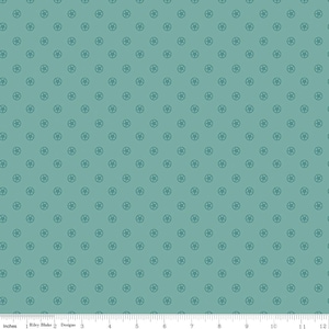 May include: Teal fabric with a repeating pattern of small, dark teal star-shaped designs. The fabric is measured in inches, with a ruler along the bottom edge. The Riley Blake Designs logo is visible.