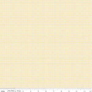 May include: A fabric with a small, light yellow and white checkered pattern. The fabric is measured in inches, with a ruler along the bottom edge. The fabric is from Riley Blake Designs.