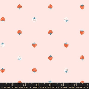 May include: A light pink fabric with a repeating pattern of strawberries. The strawberries are red with green stems, and some are white with blue stems. The fabric has the text "RUBY STAR SOCIETY" at the bottom.
