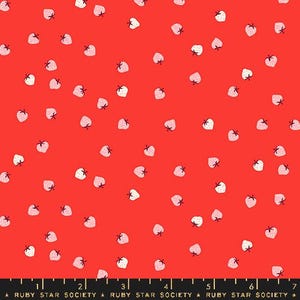 May include: Red fabric with a scattered pattern of small strawberries. Each strawberry is white with pink shading and a small green stem. The fabric has a Ruby Star Society label at the bottom.