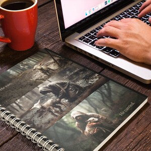 May include: A spiral bound notebook with a black cover and four images of a person in a hooded cloak carrying a lamb. The text on the cover reads "He ran", "He rescued", and "He carried".