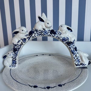 May include: A set of three ceramic mugs with a speckled, matte finish. The mugs are in shades of cream, light gray, and dark gray. Each mug has a simple, minimalist design, perfect for coffee or tea.