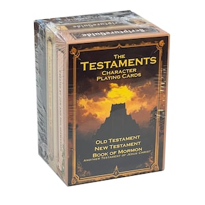 May include: A box of The Testaments Character Playing Cards, featuring a golden sunset scene with a castle silhouette. The box includes cards for the Old Testament, New Testament, and Book of Mormon.