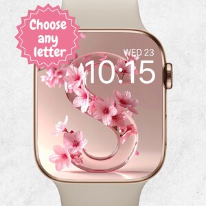 May include: A gold smartwatch with a floral design on the screen. The screen shows the letter "S" filled with pink flowers, the time 10:15, and the date. A pink starburst graphic reads "Choose any letter".