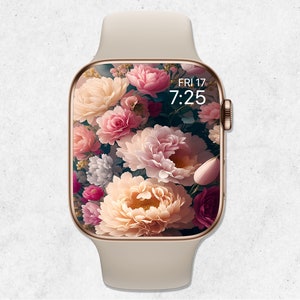 May include: A gold Apple Watch with a white band and a floral watch face. The watch face displays the time as 7:25 and the date as FRI 17.