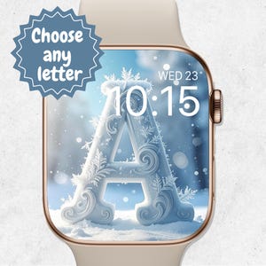 May include: A gold Apple Watch shows a winter-themed watch face with a large, ornate letter "A" covered in frost. The screen displays the time as 10:15 and the day as Wednesday the 23rd. A blue starburst graphic reads "Choose any letter".