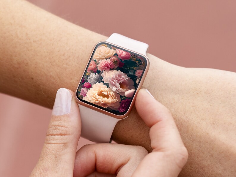 May include: A white smartwatch with a rose gold band and a floral screen saver. The screen saver features a close-up of pink, white, and yellow flowers.