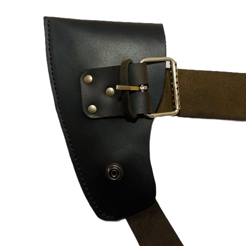May include: Black leather axe sheath with a brown strap and silver buckle. The sheath has a riveted design and a snap closure. The axe sheath is designed to protect the axe blade.