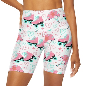 May include: White athletic shorts with a pink and blue roller skate and heart pattern.