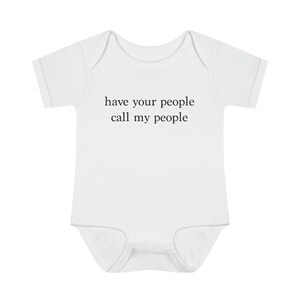 May include: White baby onesie with short sleeves and the text "have your people call my people" printed in black.