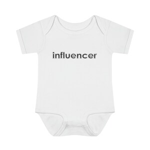 May include: White baby onesie with short sleeves and the word "influencer" printed in black.