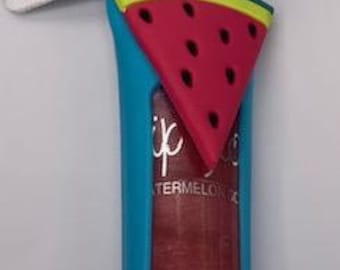Lip gloss with attached holder and mini fruit on holder