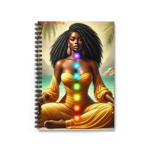 May include: A woman with dark brown hair sits in a meditative pose with her eyes closed. She is wearing a yellow dress and has seven glowing chakras along her torso. The background is a tropical beach scene.