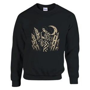 May include: A black crewneck sweatshirt featuring a beige graphic print of a person playing a saxophone in a city setting with tall buildings and a crescent moon. The design has a distressed, textured appearance on the front of the garment.