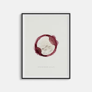May include: Framed art print featuring a watercolor design of a wine stain with a topographic map inside. The print has a black frame and the text "THE WINE STAIN TOPOGRAPHY - 41° 50' N, 87° 37' W" at the bottom.