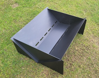 May include: Black metal fire pit with a rectangular shape and a raised lip. The fire pit has a series of holes along the bottom.