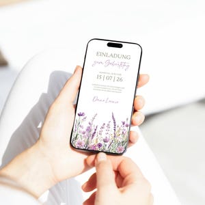 May include: A digital invitation on a smartphone screen with a floral design. The invitation reads "Einladung zum Geburtstag" and "15|07|26".