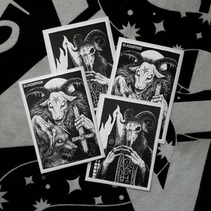 May include: Four black and white stickers featuring a goat-like demon with horns and a cross. The stickers have the text "GLASSOFEEZE" on them.