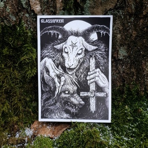 May include: Black and white illustration of a goat-like creature with horns and a pentagram on its forehead, holding a cross and a wolf-like creature in its claws. The image is on a white background with the text "GLASSOFF33R" at the top.