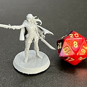 May include: A white plastic miniature figurine of a female elf warrior holding a sword, standing on a round base. The figurine is next to a red and black 20-sided die with gold numbers.