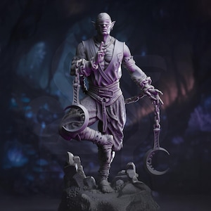 Puede incluir: Estatua detallada de una figura con los ojos vendados, sosteniendo objetos en forma de media luna unidos a cadenas. La figura está de pie sobre una base rocosa, con detalles intrincados en la ropa y la pose. La paleta de colores es principalmente tonos de gris y púrpura.