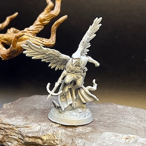 May include: A gray plastic miniature figurine of a winged humanoid figure with a bow and arrow. The figure is posed in mid-air with wings spread and a cloak flowing behind it.