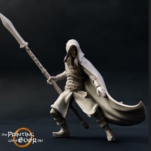 May include: A white 3D printed miniature of a hooded figure holding a spear. The figure is wearing a long cloak and has a determined expression on their face.