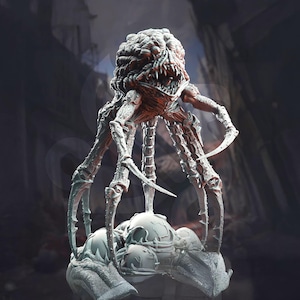 May include: A detailed, three-dimensional sculpture of a monstrous creature. The figure has a large, textured head with sharp teeth and multiple limbs ending in curved claws. The creature is primarily gray with reddish accents.