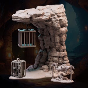 May include: A miniature scene depicting a rocky cave with a hanging cage and a figure trapped on a wooden spit. The scene is painted in a neutral gray color.