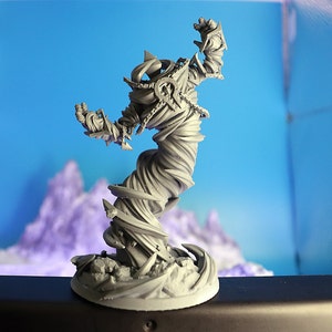 May include: A grey, 3D printed miniature of a swirling, humanoid figure with a textured surface. The figure is posed with one arm raised and appears to be made of swirling, twisting fabric.