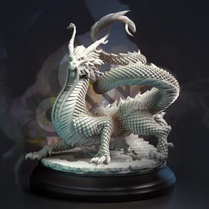 May include: A detailed white dragon sculpture with a textured, scaled body and intricate details. The dragon is posed dynamically on a stone base, mounted on a black circular stand. The sculpture has a long, flowing tail and a detailed head.