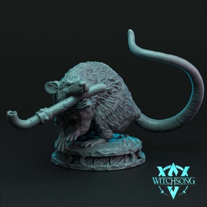 May include: A gray, detailed miniature of a rat holding a pipe in its mouth. The rat is standing on a circular base with intricate details. The miniature is made of a smooth, textured material.
